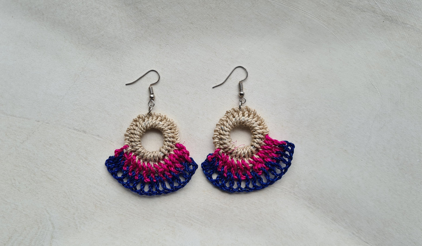 Pair of Dusk patterned Sepik Handwoven earrings on a light background, Front view