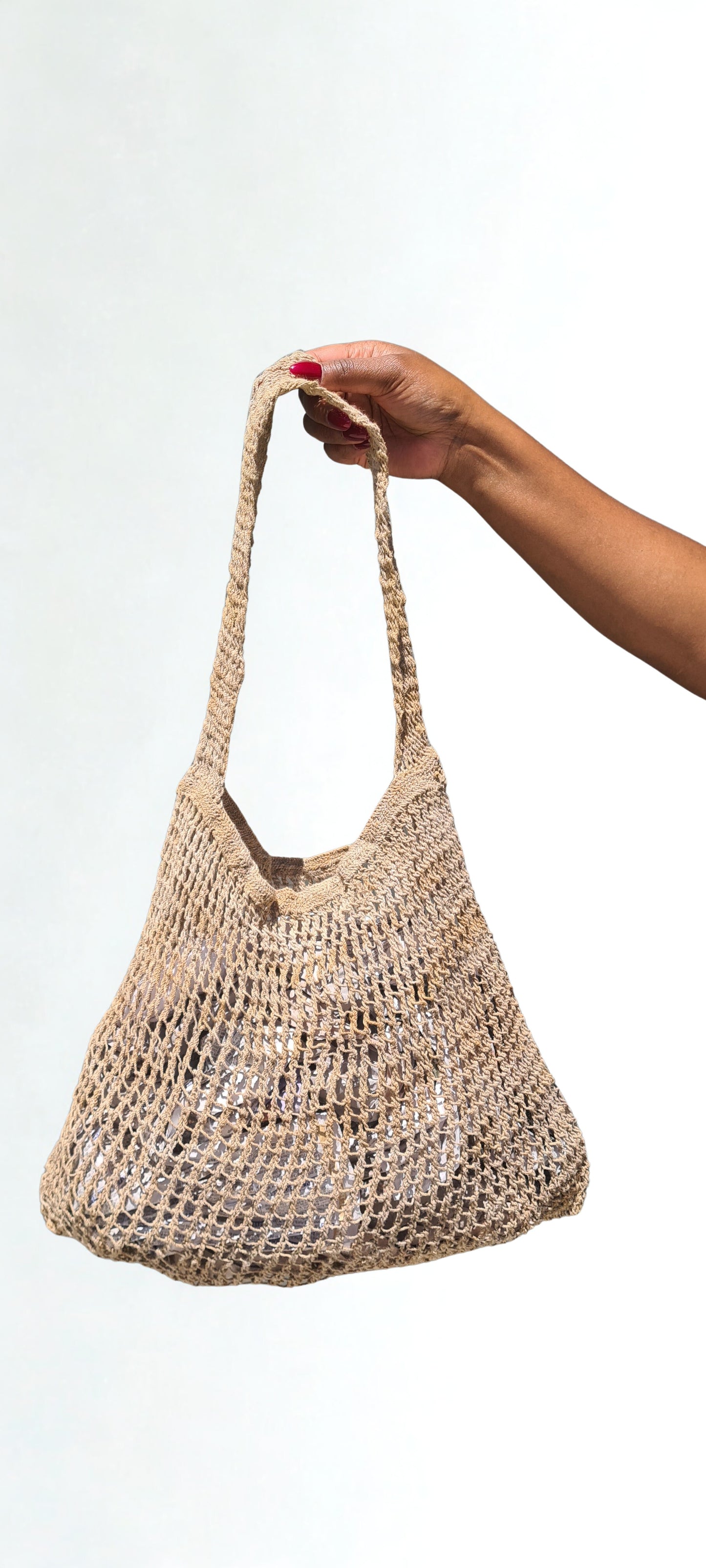 Handmade Natural Fibre Tulip Bilum Bag with Beige pattern on light background, Hanging Front view
