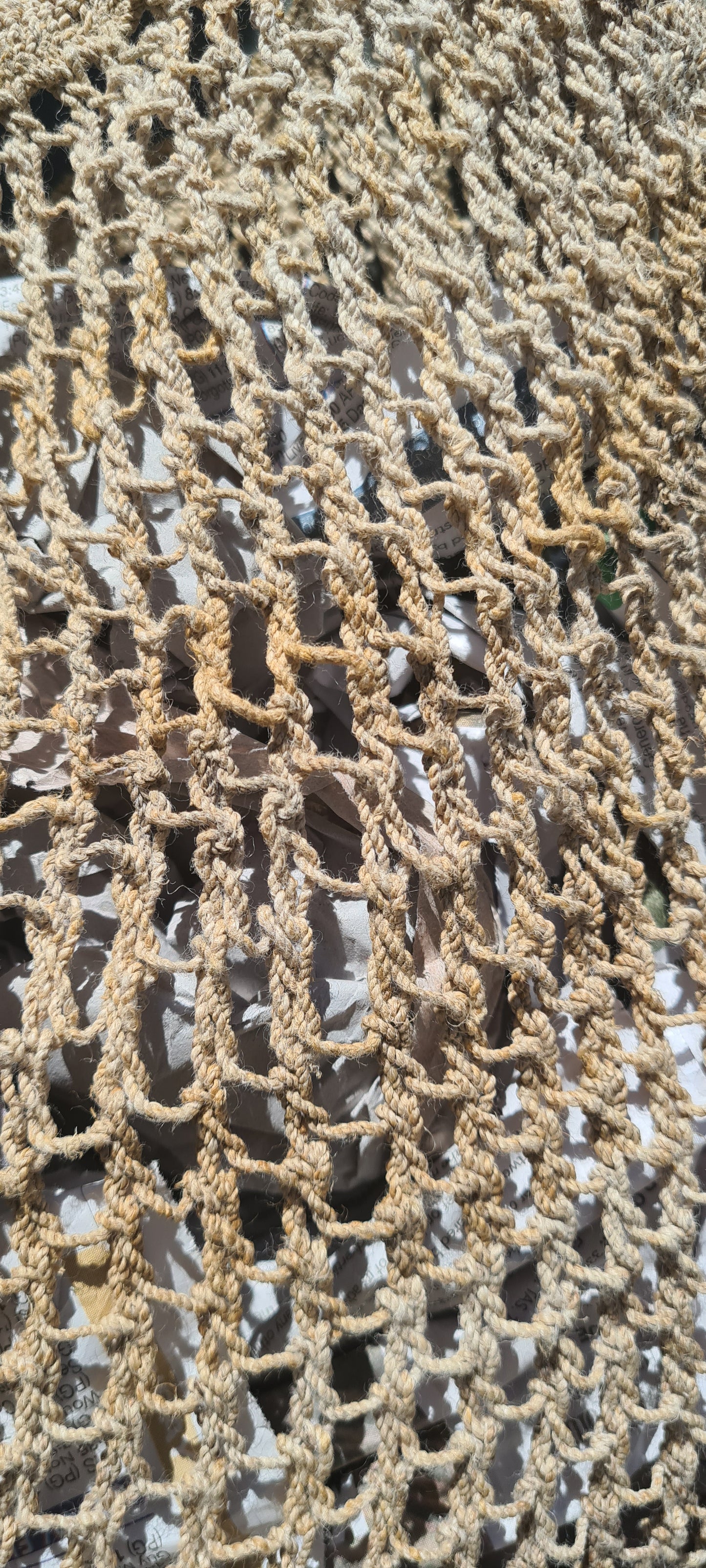 Handmade Natural Fibre Tulip Bilum Bag with Beige pattern on light background, Close Up view