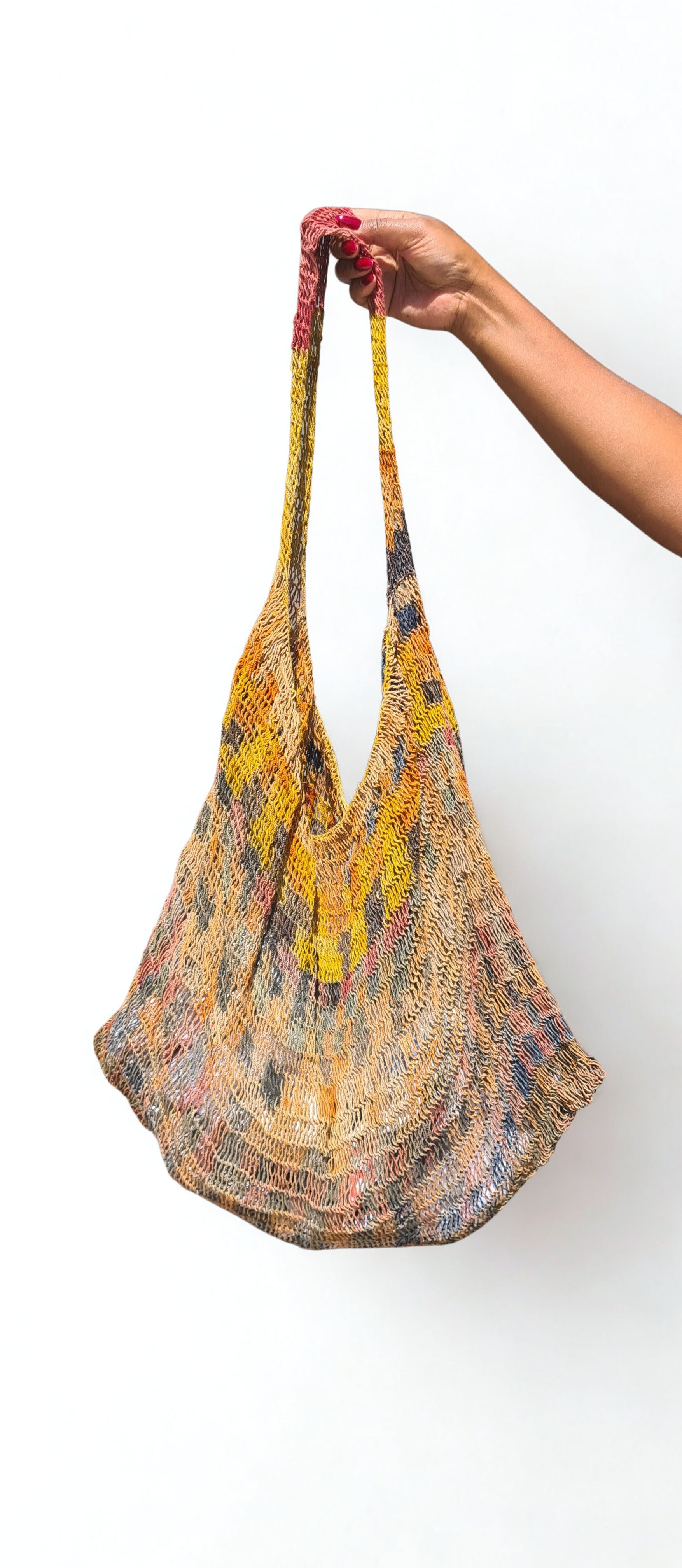 Handmade Natural Fibre Tulip Bilum Bag with Rainbow pattern on light background, Hanging Front view