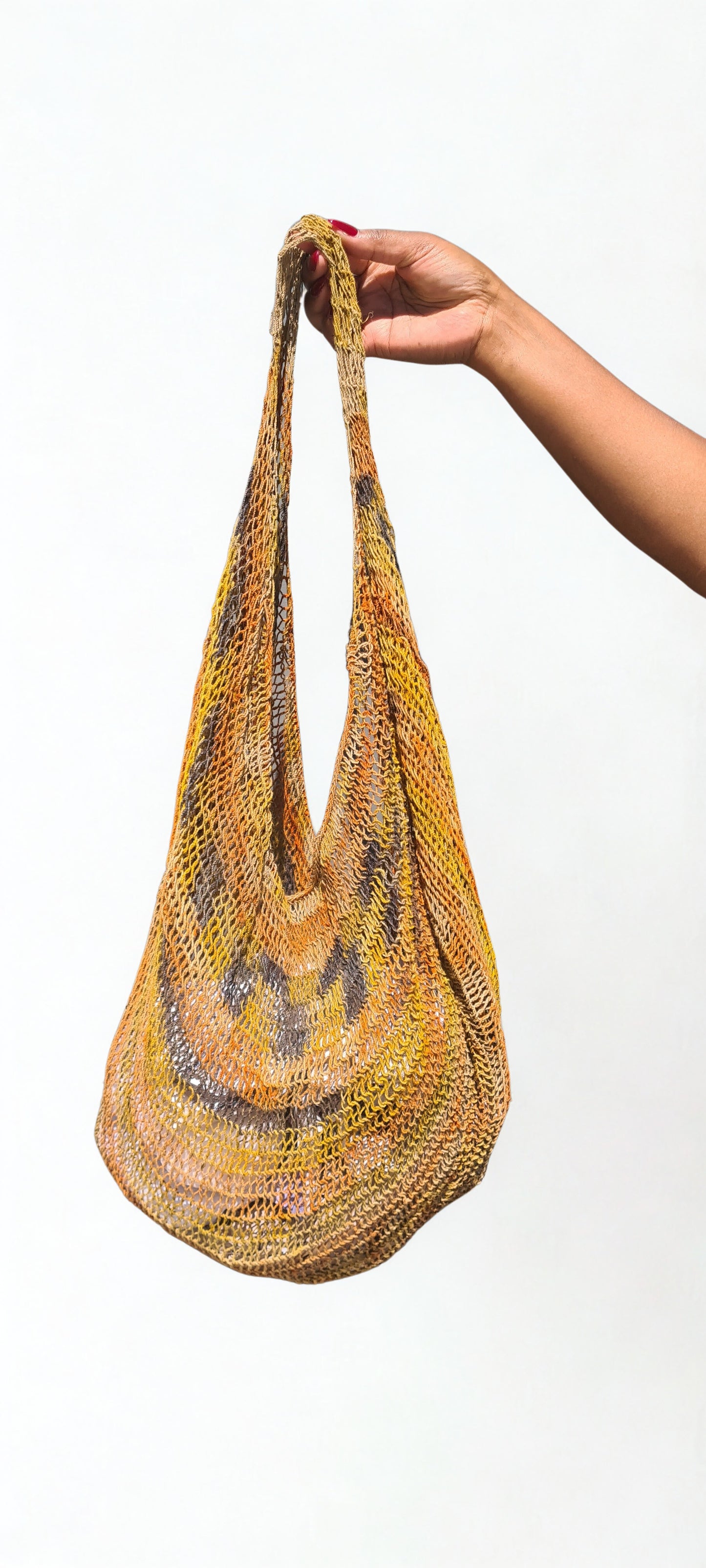 Handmade Natural Fibre Tulip Bilum Bag with Tumeric pattern on light background, Hanging Front view