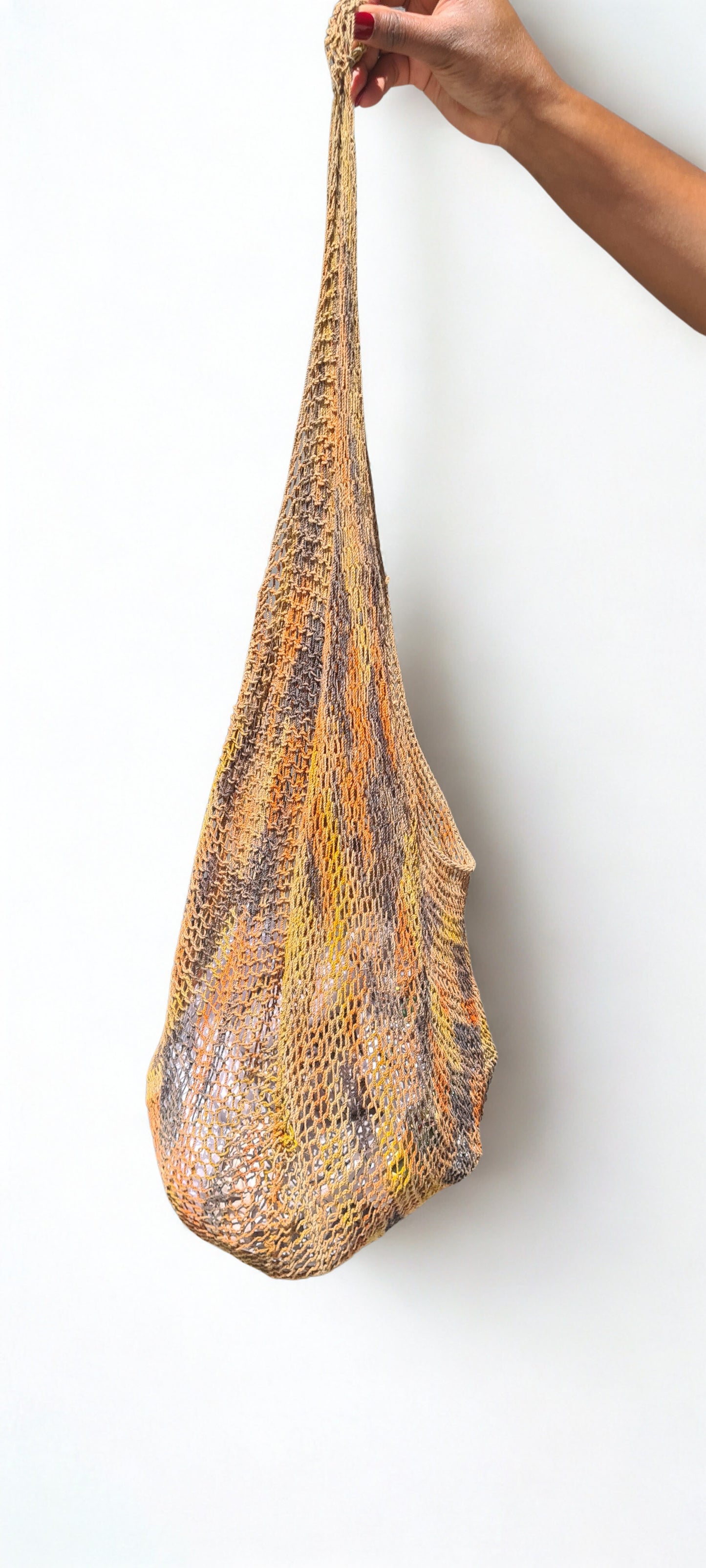 Handmade Natural Fibre Tulip Bilum Bag with Charcoal multicolour pattern on light background, Hanging Side View