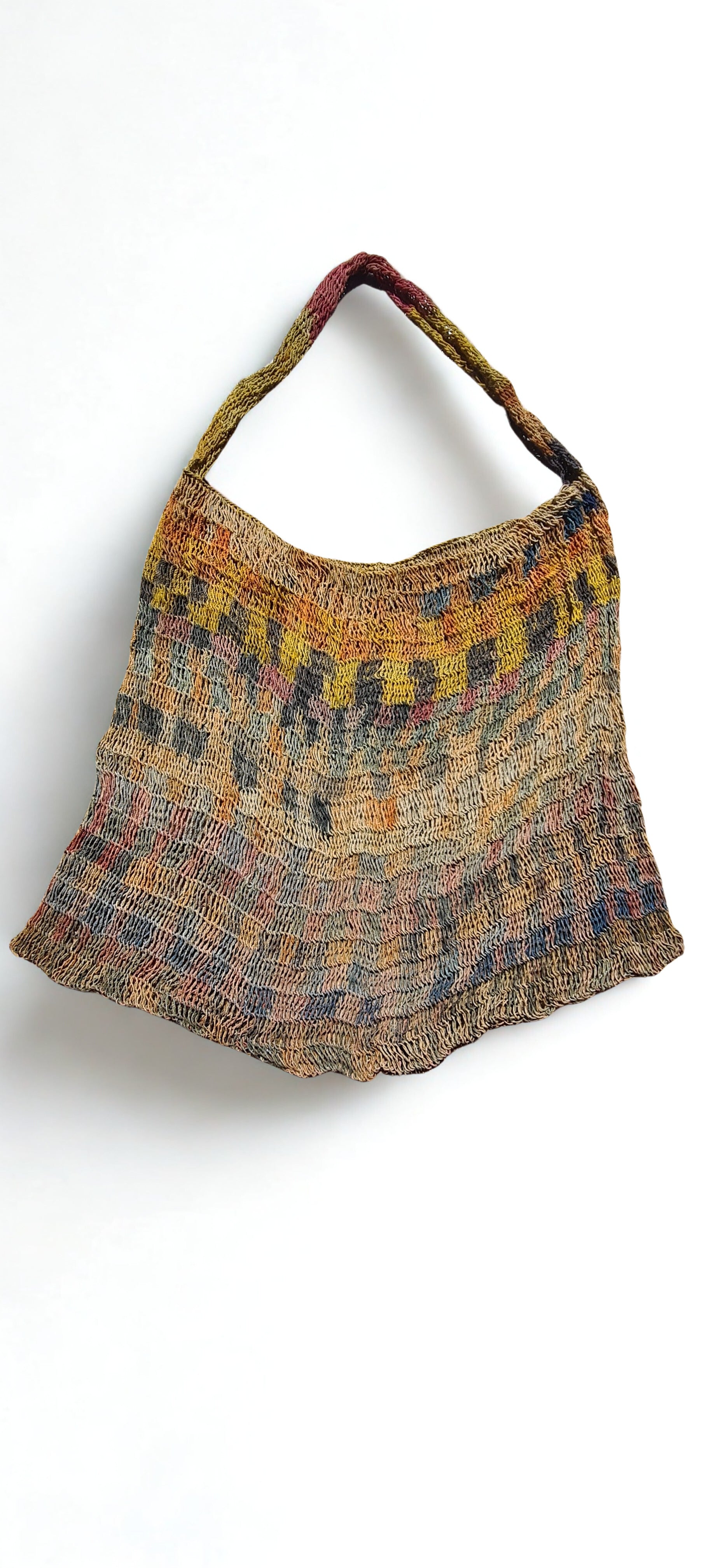 Handmade Natural Fibre Tulip Bilum Bag with Rainbow pattern on light background, Flat Lay Front view