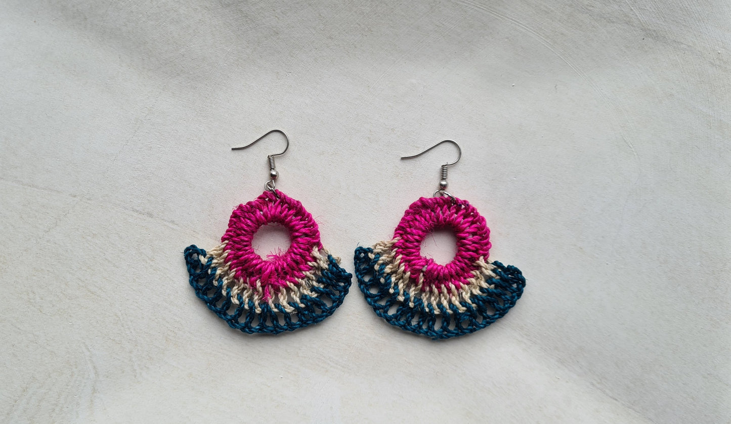Pair of Hibiscus patterned Sepik Handwoven earrings on a light background, Front view