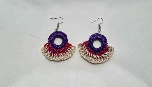 Pair of Midnight patterned Sepik Handwoven earrings on a light background, Front view