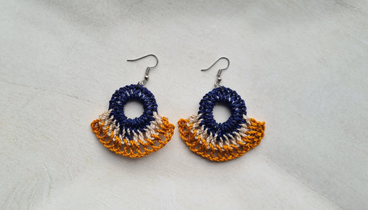 Pair of Niu Ailan patterned Sepik Handwoven earrings on a light background, Front view